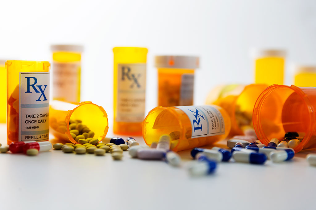 Prescription bottles and pills on a counter